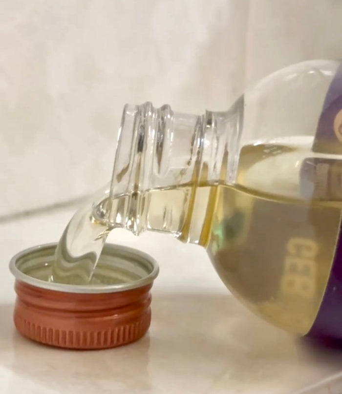 Pouring oil (clear drop), product in glass.